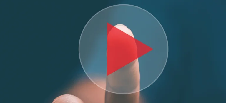 A finger poised to press a red play button, set against a soft blue background, symbolizing video playback.