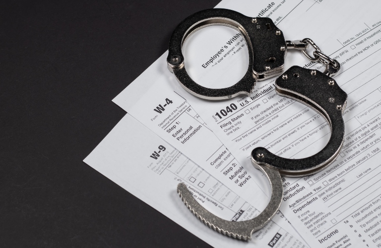 tax return documents and handcuffs
