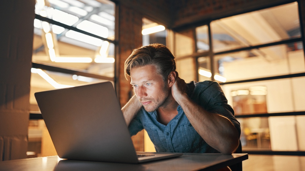 confused man is sitting with laptop