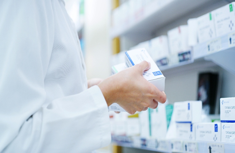 pharmacist holding medication