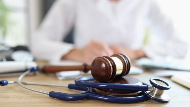 judge's gavel, stethoscope and doctor