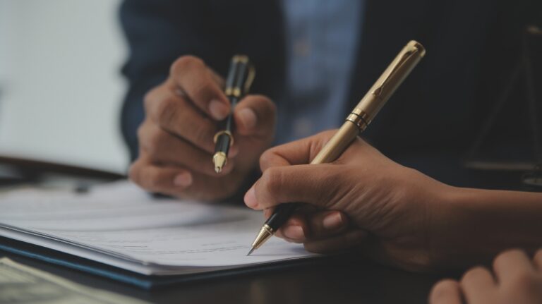 Lawyer is showing client where to sign document